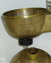 The entire vessel is made from brass and the bottom hemisphere has an inside lip that allows both halves to be pushed together to make perfect electrical contact. A motorized soft iron magnet is used beneath the bottom hemisphere to stir the teflon magnet inside the reaction vessel.