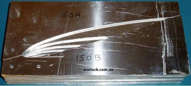 Airfoil cross sectons are cut out of aluminium sheet. They are shown over-layed from smallest to largest in order of their position along the wing.