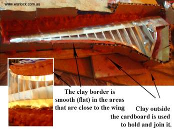 Make a border (molding clay is shown below) to support the casting mixture (plaster/gauze shown below. Can also use plaster/fiberglass or fiberglass/fiberglass resin).